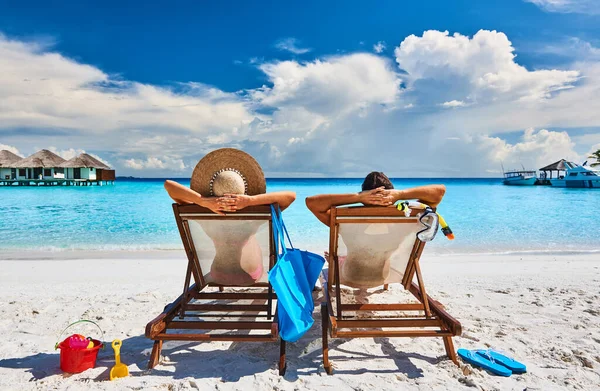 depositphotos_354422918-stock-photo-couple-sun-beds-tropical-beach